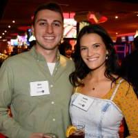 Two alumni standing together at Kings Dining and Entertainment.